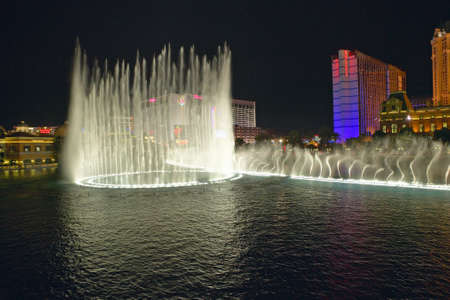 Bellagio Casino Water Show at night with Paris Casino and Eiffel Tower, Las Vegas, NVのeditorial素材