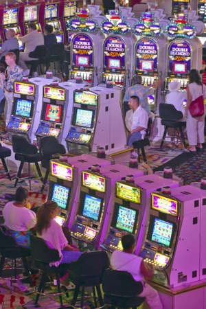 Rows of slot machines and gamblers at Rio Casino in Las Vegas, NVのeditorial素材