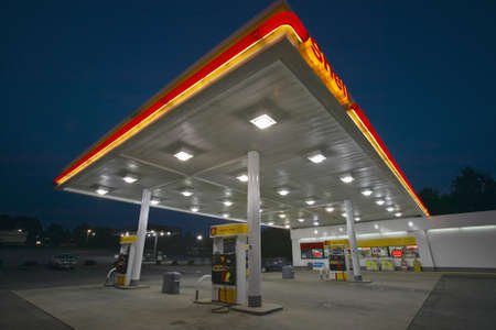 Gas Station with lights on and mini-mart at dusk in Central GAのeditorial素材