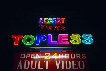 Topless neon sign advertising a strip club and Adult Video store near Phoenix AZのeditorial素材
