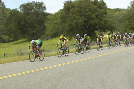 A group of road bicyclists traveling across highway 58 in CAのeditorial素材