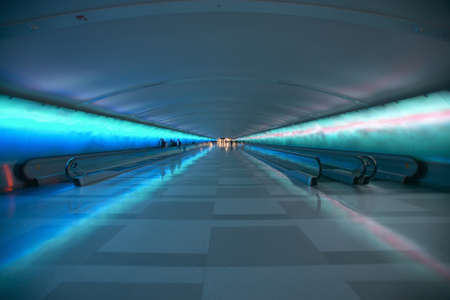 Moving sidewalks and a changing light show in the tunnel of the Detroit Airport, Detroit, Michiganのeditorial素材