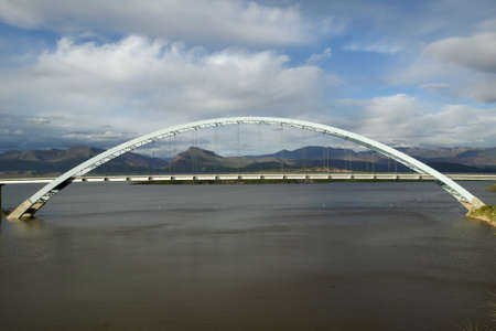 An arched bridge over Theodore Roosevelt Lake, near the Roosevelt Dam at the intersection of 88 and 188, west of Phoenix AZのeditorial素材