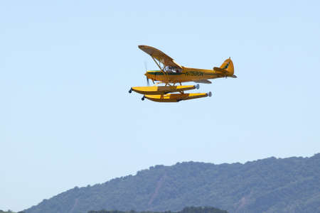 Yellow amphibious seaplane taking off from Lake Casitas, Ojai, Californiaのeditorial素材