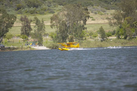 Yellow amphibious seaplane taking off from Lake Casitas, Ojai, Californiaのeditorial素材