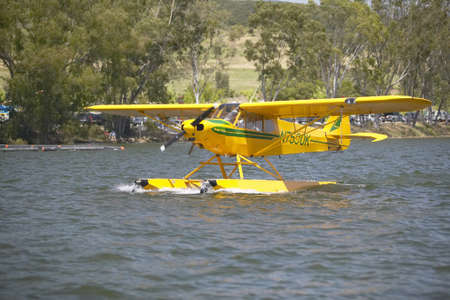 Yellow amphibious seaplane taking off from Lake Casitas, Ojai, Californiaのeditorial素材