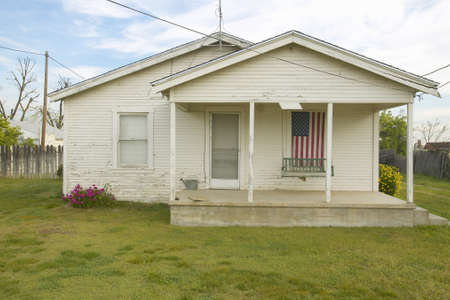 Old swing on porch displaying an American Flag and patriotic theme near Barstow CA off Route 58のeditorial素材