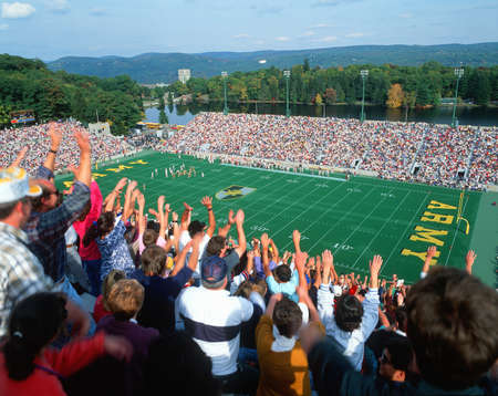 Crowd doing the wave at a college football game in Michie Stadium, New Yorkのeditorial素材