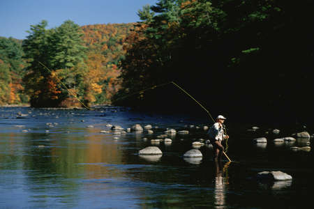 Solitary fly fisherman on Housatonic River in autumn, Connecticutのeditorial素材