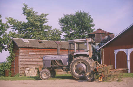Tractor in front of a barn in Mottville, MIのeditorial素材
