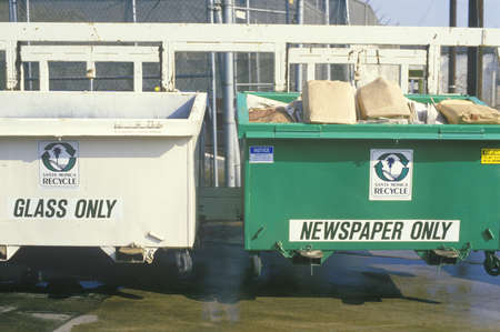 Separate recycling bins for glass and newspaperのeditorial素材