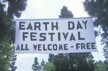 A hanging sign welcoming people to the Earth Day Festivalのeditorial素材