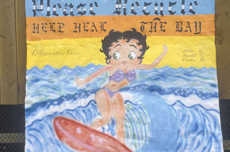 A painting of Betty Boop on a surfboard asking to please recycleのeditorial素材