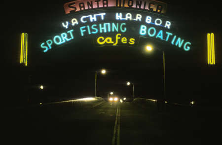 A neon sign that reads "Yacht Harbor, sport fishing boating cafes"のeditorial素材