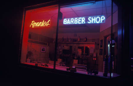 A neon sign that reads "Ronnie's Barber Shop"のeditorial素材