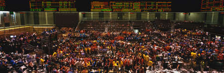 This is the Chicago Board of Trade trading floor. It is where they trade commodity futures such as corn, wheat, and gold. The floor is full of traders and the lighted boards showing prices are at the top of the walls. This is the Chicago Board of Trade trading floor. It is where they trade commodity futures such as corn, wheat, and gold. The floor is full of traders and the lighted boards showing prices are at the top of the walls.