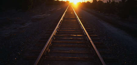 These are railroad tracks that go off into infinity at sunrise. The sun is at the end of the tracks...