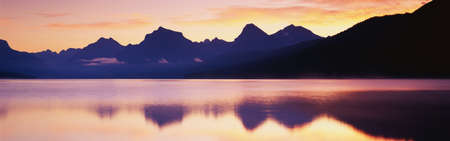 This is Lake McDonald. There is a reflection of the mountains in the lake.の写真素材