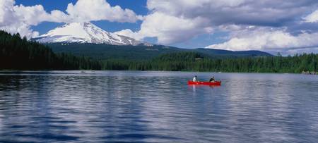 This is snow capped Mount Hood and Trillium. There is a canoeist in a red canoe on the lake .のeditorial素材