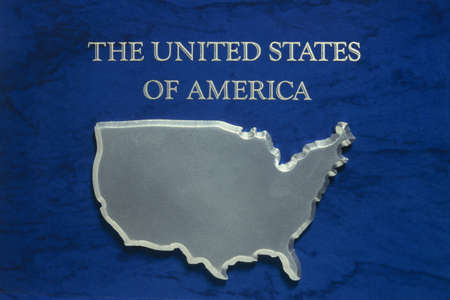 This is a map in silver of the United States of America against a blue background. It is labeled The United States of America.のeditorial素材