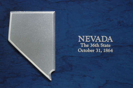 This is a silver map of the state of Nevada against a blue background. It says, Nevada, the 36th State, October 31, 1864 which is the date it entered the Union.のeditorial素材