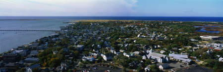 This is an aerial view of Cape Cod. We see the ocean on the left hand side and the new England town of Provincetown on the right. の写真素材