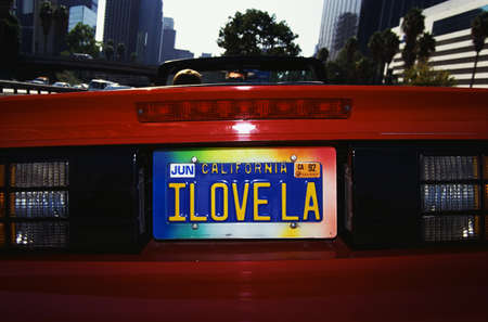 This is a vanity license plate that says, I Love LA. It is on a red convertible sports car.のeditorial素材