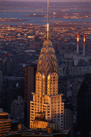 This is the skyline with the Chrysler Building prominent in the center. It is sunset on the city.