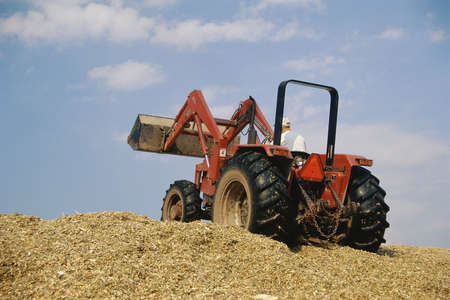 Tractor riding up hillの写真素材