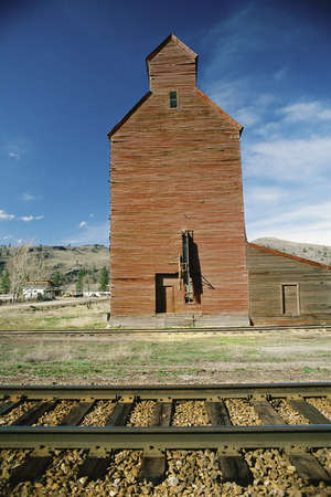 Grain elevator beside railroad tracksの写真素材