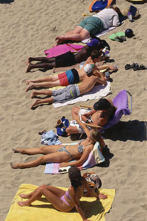 Sunbathers lying on beachのeditorial素材