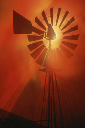 Windmill against red sky