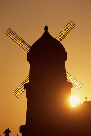 Classic windmill against sunsetの写真素材