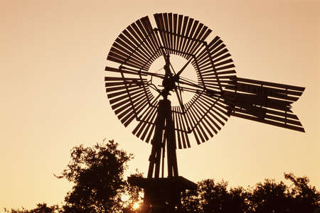 Top of windmill against pale orange skyの写真素材