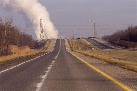 Highway with industrial cloud in backgroundの写真素材