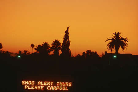 Smog alert sign against Los Angeles silhouetteの写真素材