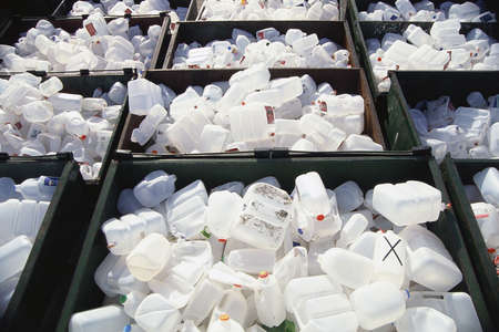 Dumpsters filled with plastic jugs
