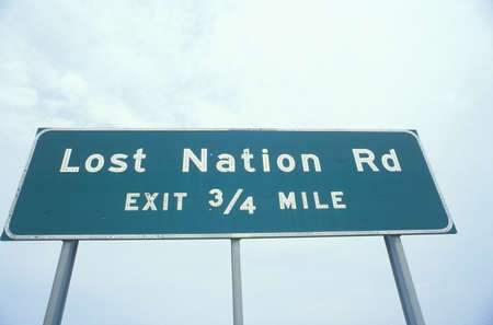 A sign that reads ÒLost Nation Rd - Exit 3/4 mileÓ