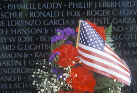 Flag and Flowers in front of Vietnam Wall Memorial, Washington, D.C.のeditorial素材