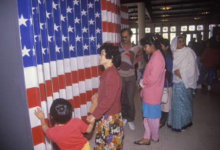 Ethnic family visiting an exhibit at Ellis Island National Park, New York