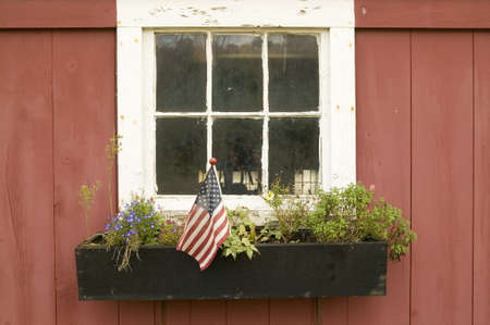 American flag displayed in flower pot of house window off of Manchester Road, St. Louis County, Missouriのeditorial素材