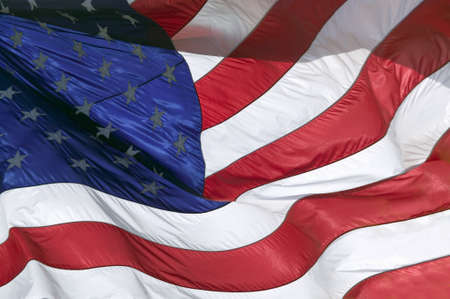 The stars and stripes, and red, white and blue colors of a US Flag blow in the wind.のeditorial素材