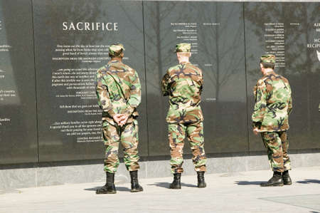 Three servicemen look at granite inscription on wall of Air Force Memorial, Arlington, Virginia in Washington D.C. areaのeditorial素材