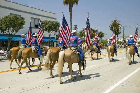 Cowboys marching with American Flags displayed during opening day parade down State Street, Santa Barbara, CA, Old Spanish Days Fiesta, August 3-7, 2006のeditorial素材