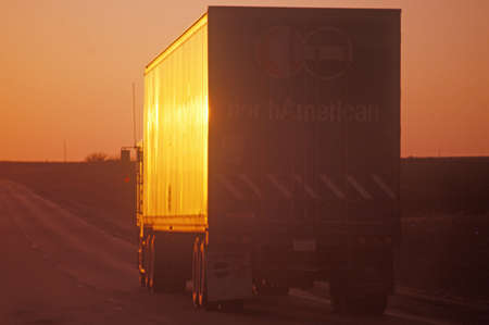 A truck on Interstate 70 at sunset in Kansasのeditorial素材