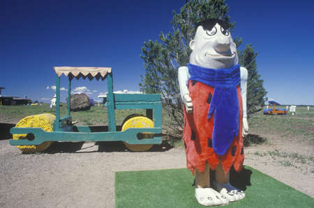 A statue of Fred Flintstone and the Flintstone vehicle at Fred Flintstone Land in Arizona, near the...
