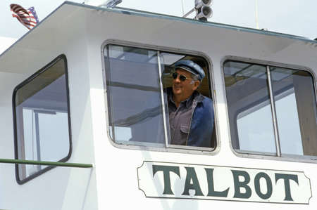 The pilot of the Oxford Ferry looking out the window of his bridge, Chesapeake Bay, Maryland