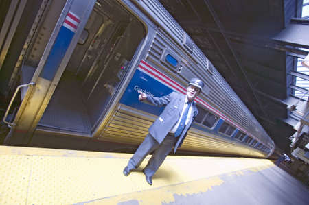 "Angled view of conductor at Amtrak train platform announces ""All Aboard"" at East Coast train station on the way to New York City, New York, Manhattan, New York"のeditorial素材