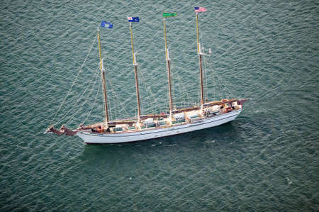 A tall ship with sails down cruises in bay outside of Acadia National Park, MEのeditorial素材