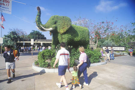 Tourists entering the San Diego Zoo, CA, with elephant topiary